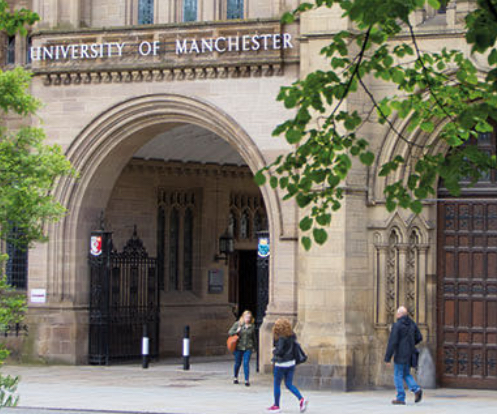 Students moving about in front of University of Manchester campus
