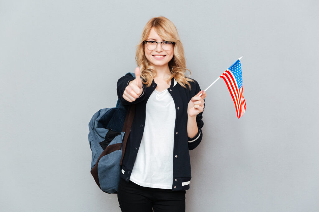 Female student holding USA flag