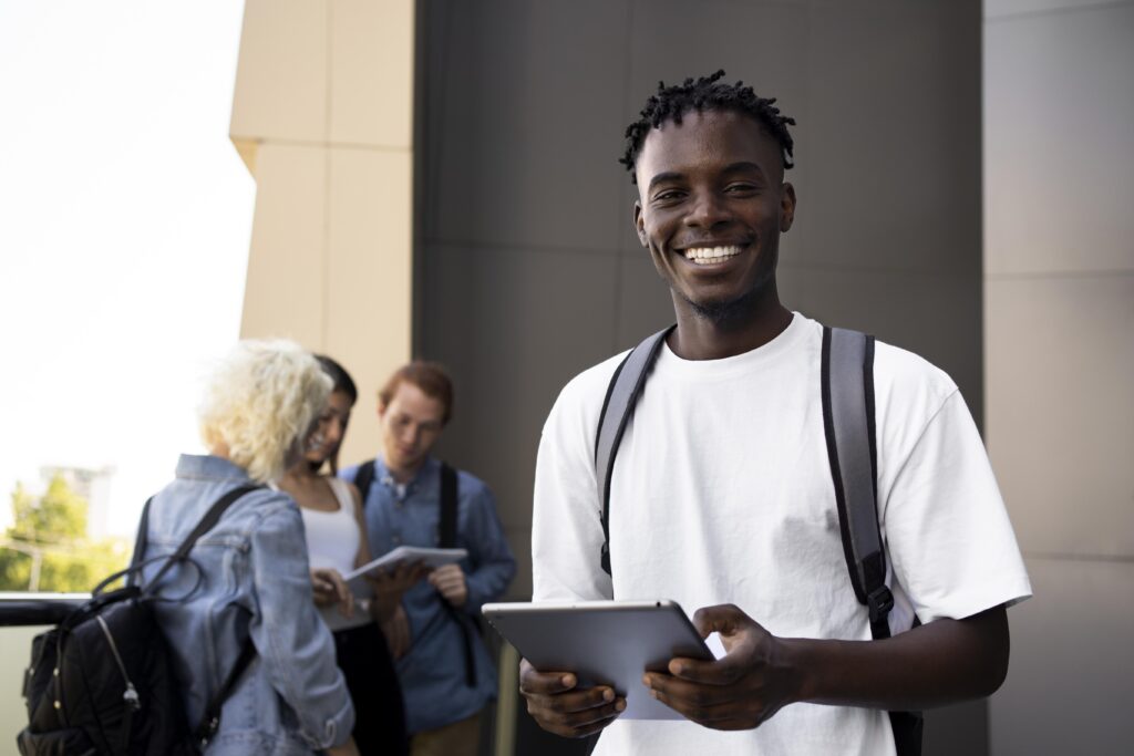 Smiling black student with other white students behind